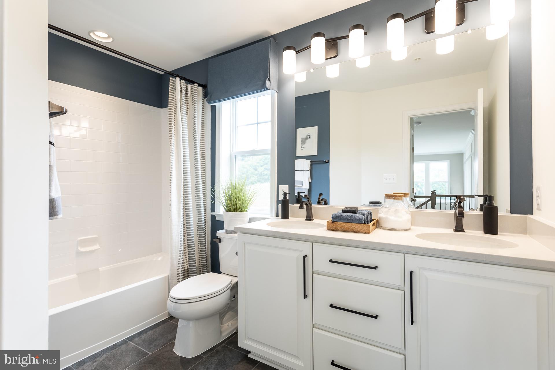 669 Burnlea Road Charles Town, WV 25414 - Photo 21 of 48 a bathroom with a double vanity sink toilet mirror and bathtub