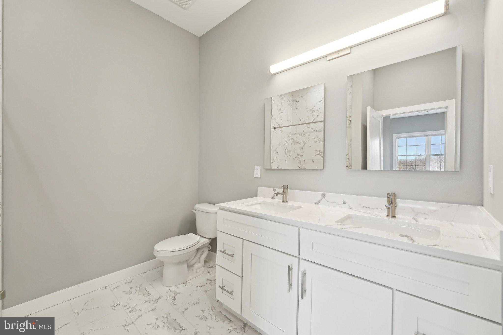 2421 Bristol Road, Unit 204 Warrington, PA 18976 - Photo 15 of 16 a bathroom with a toilet sink and mirror