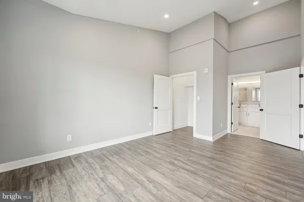 a view of an empty room and wooden floor