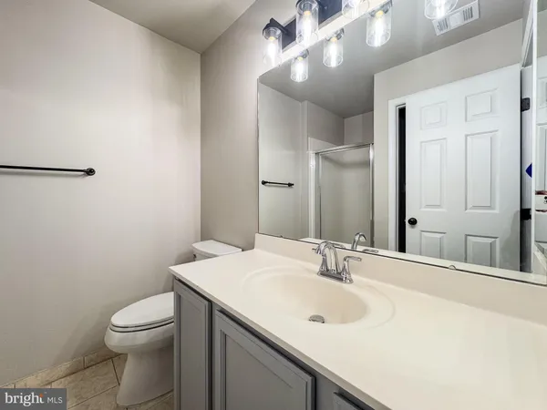 a bathroom with a sink a mirror and a shower
