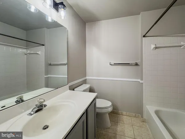 a bathroom with a sink a toilet and bathtub