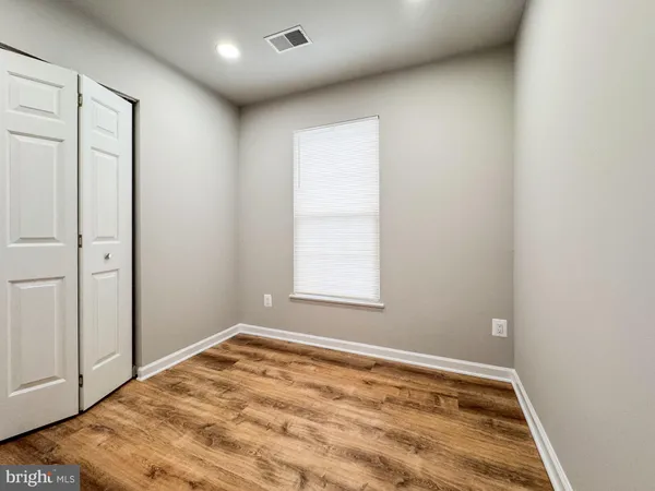 a view of empty room with a fireplace