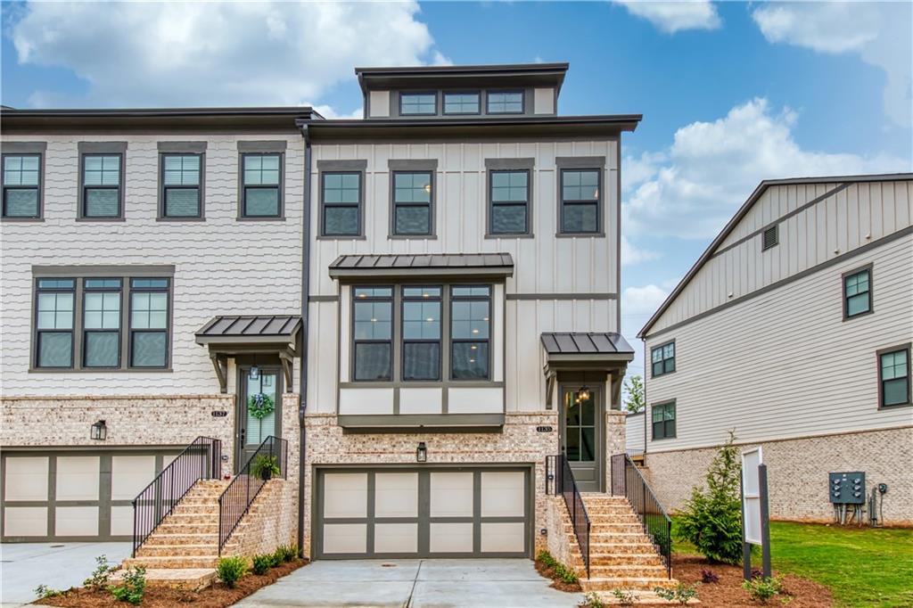 Classically styled, Craftsman exterior.  This Bremen plan is one of the largest floor plans offered at Dumont Place by Ashton Woods Homes.  Board and Batten accents with brick at the terrace level. End unit