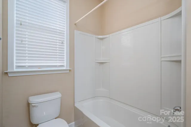 a bathroom with a toilet and shower