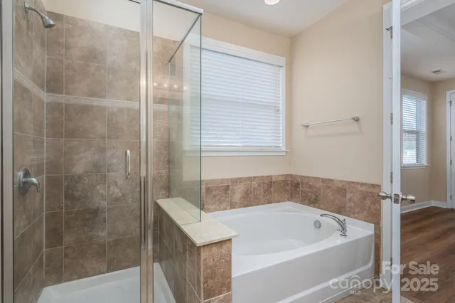 a bath tub sitting next to a shower