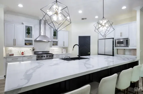a spacious bathroom with a granite countertop sink a mirror and a shower