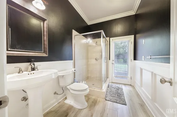 a bedroom with a bed a window and a flat screen tv