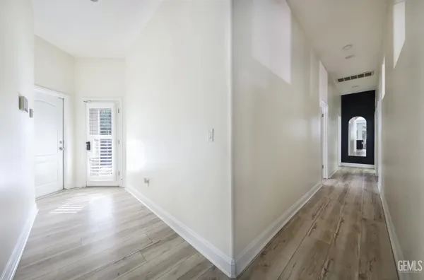 a view of a hallway with a washer and dryer