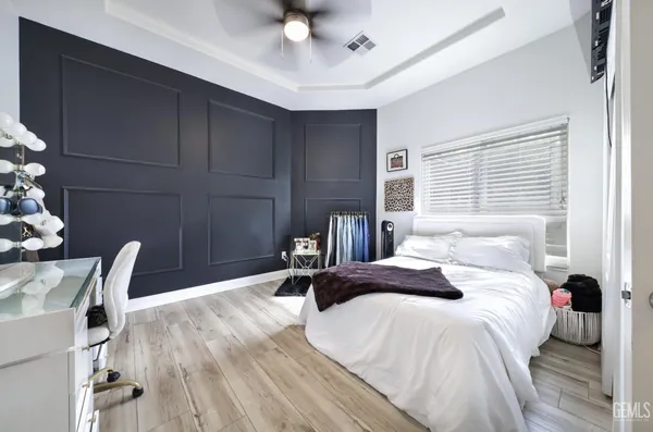 a large bathroom with a double vanity sink a large mirror and a bathtub