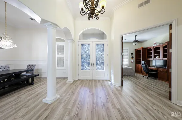 a kitchen with kitchen island granite countertop a sink a counter space appliances and cabinets