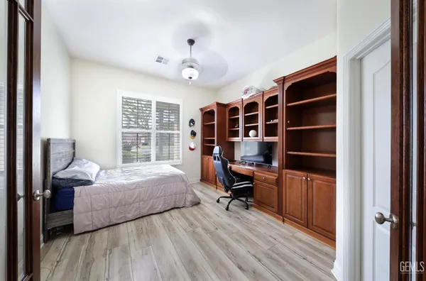 a bedroom with a bed and a chandelier