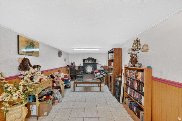 977 23rd Street Ogden, UT 84401 - Photo 23 of 29 Interior space featuring a wainscoted wall, wooden walls, light tile patterned floors, and a textured wall