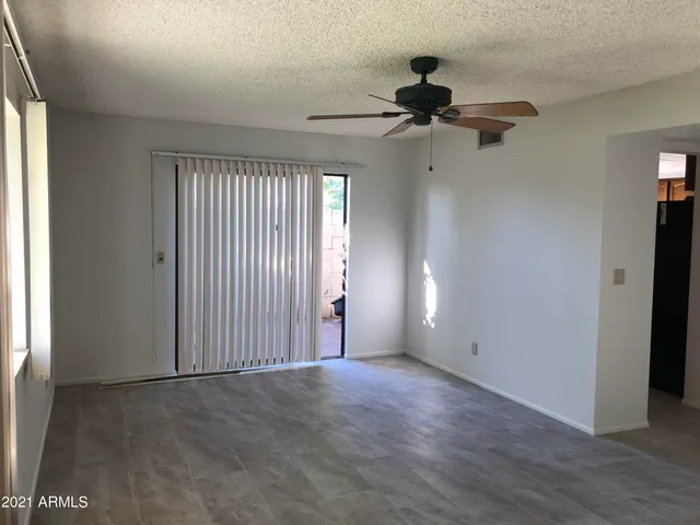 a view of empty room with ceiling fan