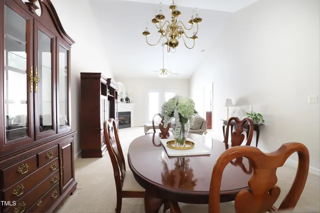 a view of a dining room with furniture a chandelier and wooden floor