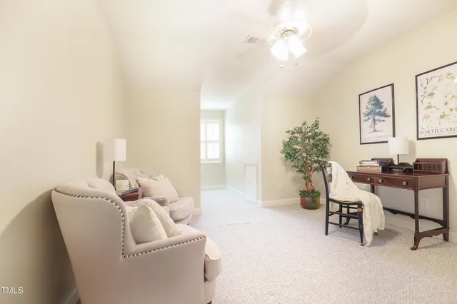 a view of a livingroom with furniture and a chandelier fan