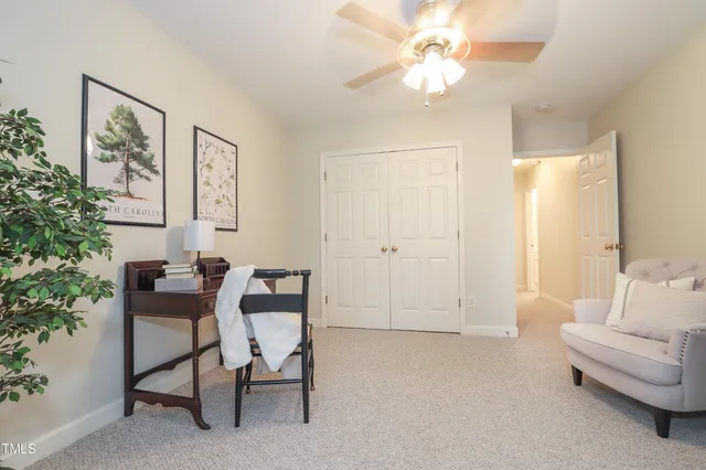 a living room with furniture and white walls
