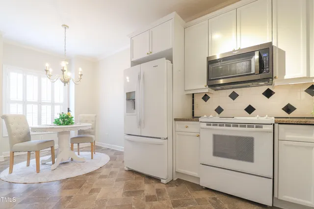 a kitchen with a stove a sink and a refrigerator