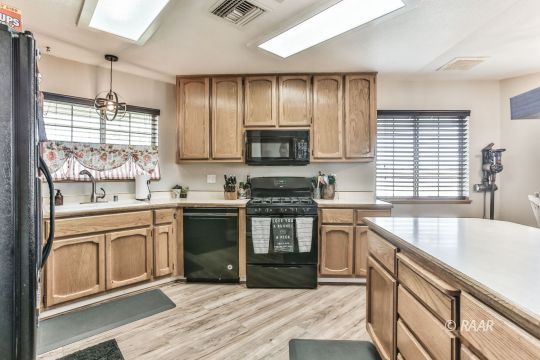 340 North Kern Street Ridgecrest, CA 93555 - Photo 8 of 33 a kitchen with granite countertop a stove sink and microwave