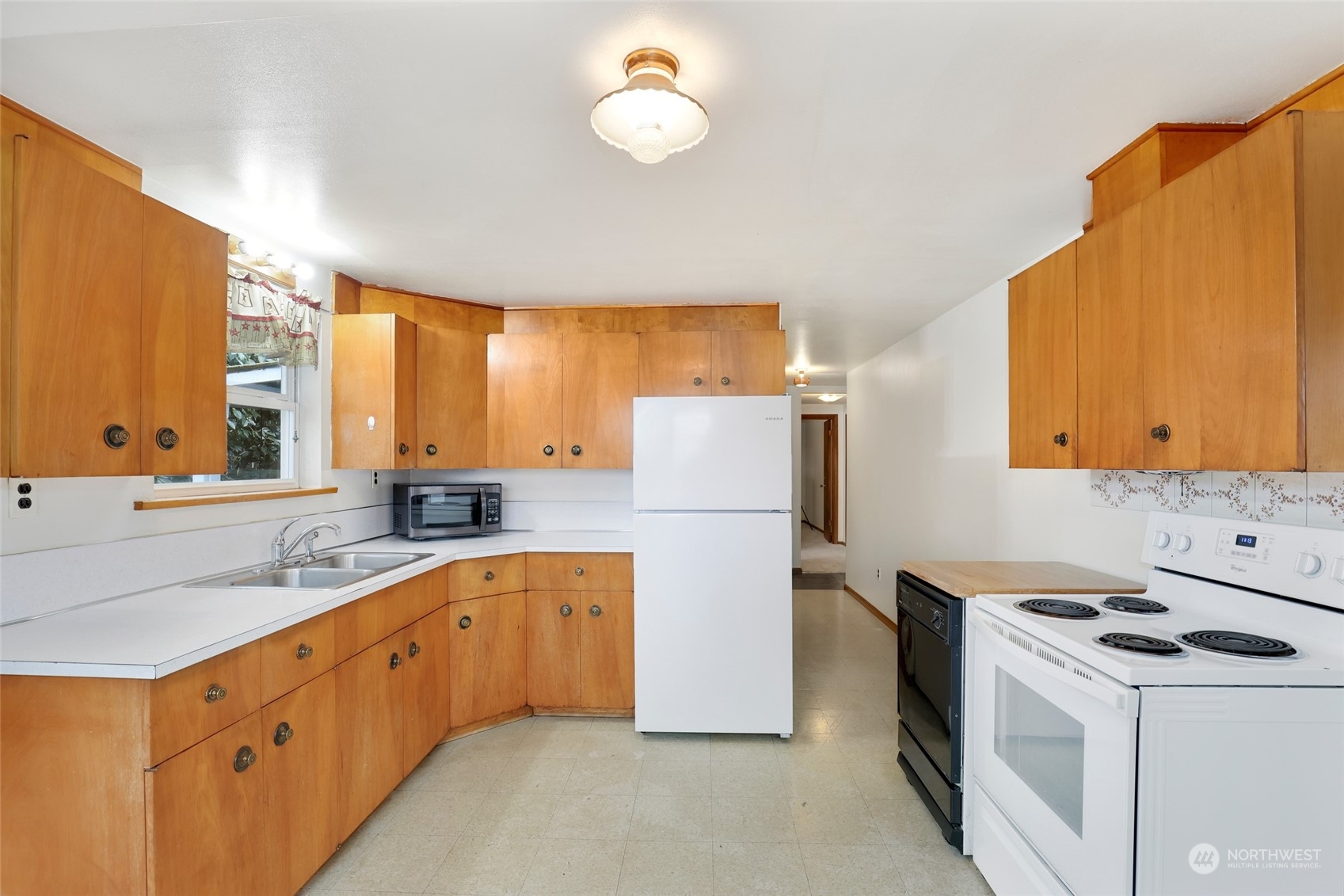 1608 Shattuck Avenue South Renton, WA 98055 - Photo 11 of 38 a kitchen with a sink a refrigerator and a stove