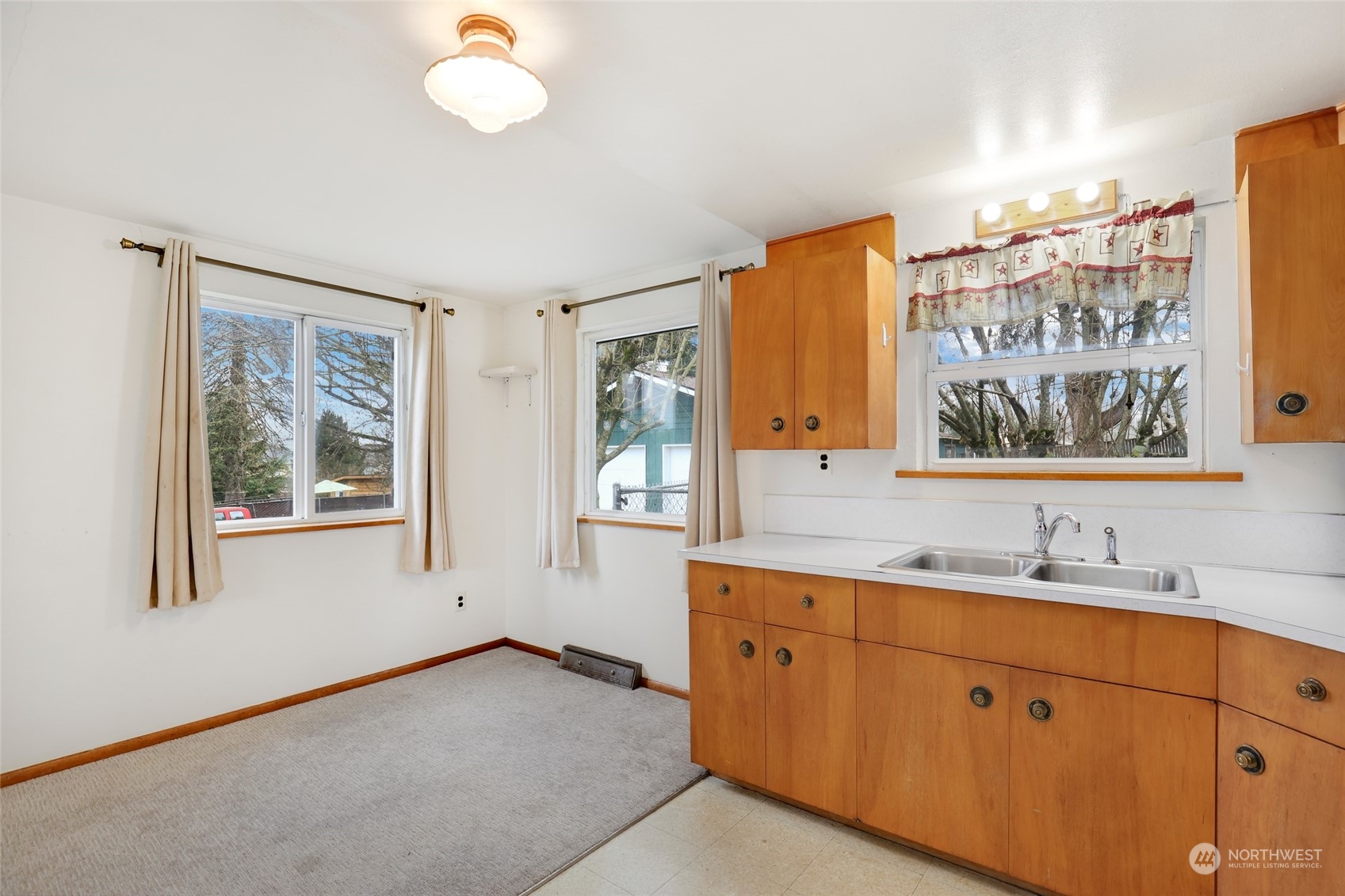 1608 Shattuck Avenue South Renton, WA 98055 - Photo 13 of 38 a bathroom with a double vanity sink a mirror and a window