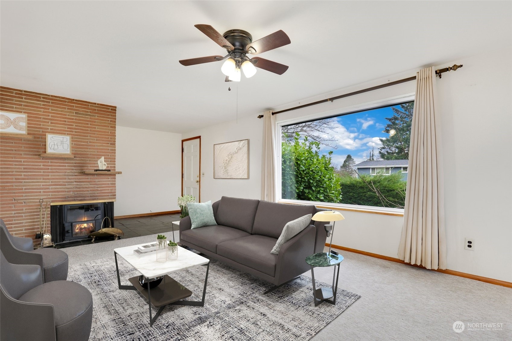 1608 Shattuck Avenue South Renton, WA 98055 - Photo 5 of 38 a living room with furniture a fireplace and a large window