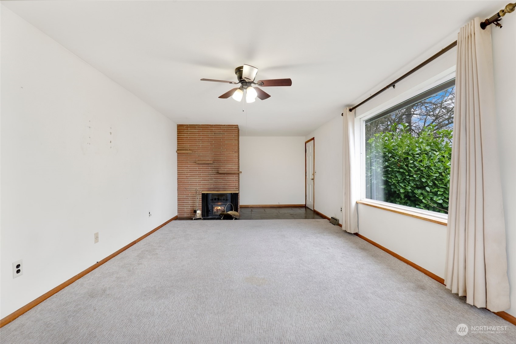 1608 Shattuck Avenue South Renton, WA 98055 - Photo 6 of 38 an empty room with windows and chandelier fan