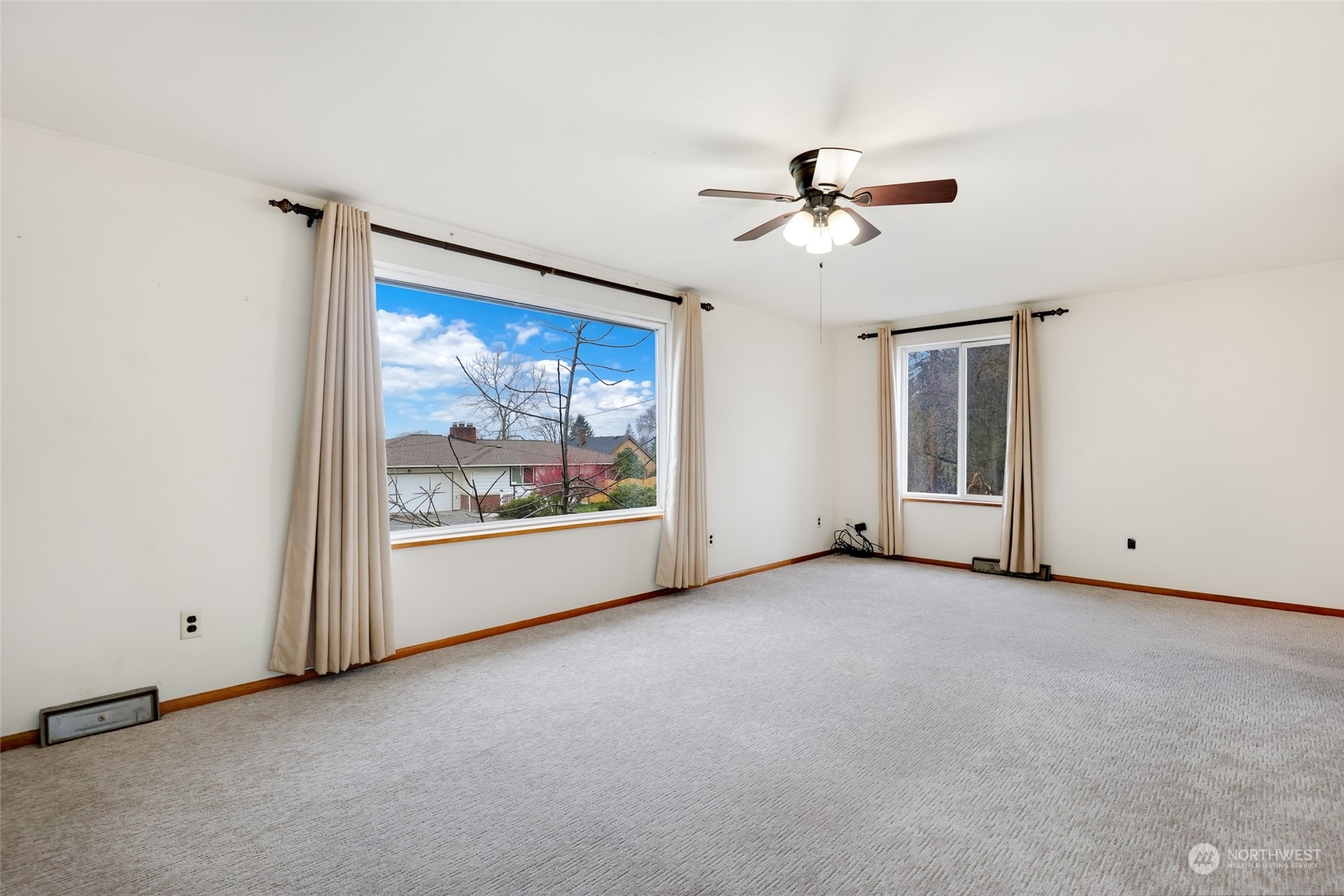 1608 Shattuck Avenue South Renton, WA 98055 - Photo 8 of 38 an empty room with chandelier fan and windows