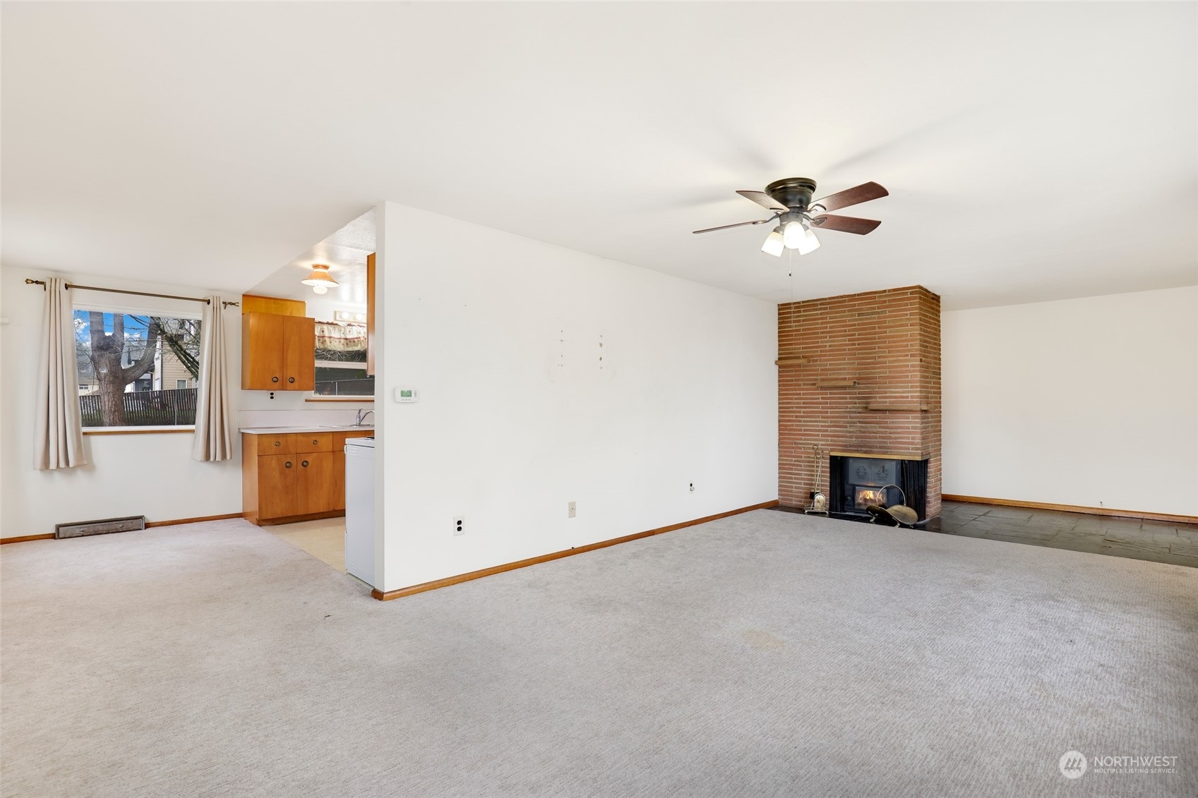 1608 Shattuck Avenue South Renton, WA 98055 - Photo 9 of 38 an empty room with windows and chandelier fan