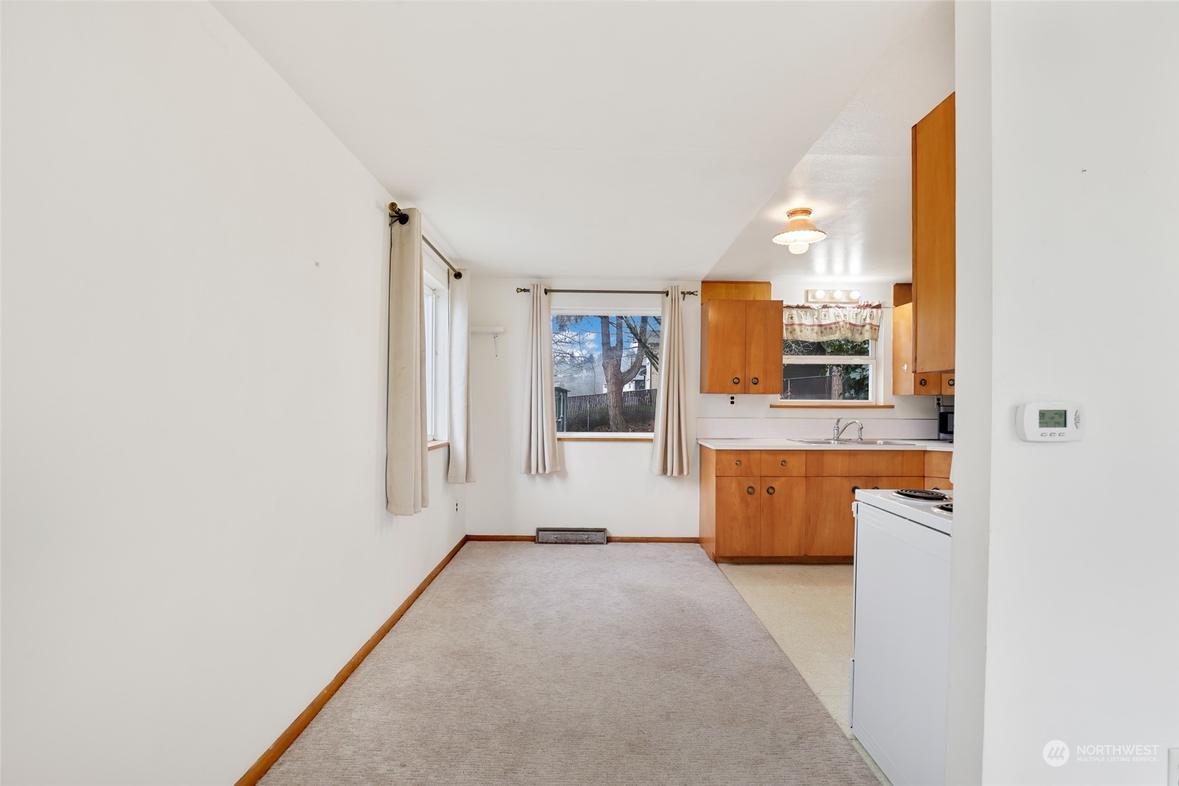 1608 Shattuck Avenue South Renton, WA 98055 - Photo 10 of 38 a view of a kitchen with wooden floor and a window