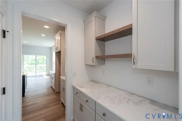 a kitchen with granite countertop white cabinets and appliances