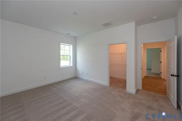 a view of wooden floor and windows in an empty room