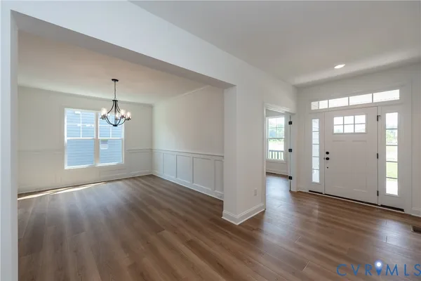 a view of an empty room and wooden floor