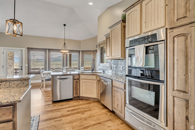 3054 West Ridgeline Road Stockton, UT 84071 - Photo 38 of 88 Kitchen with stainless steel appliances, hanging lights, a warming drawer, light wood finish cabinetry, and vaulted ceiling
