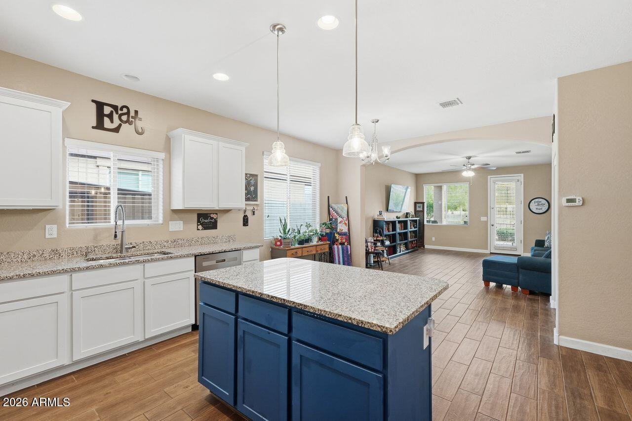 23602 West Ripple Road Buckeye, AZ 85326 - Photo 14 of 38 a large kitchen with kitchen island a sink appliances and a counter space