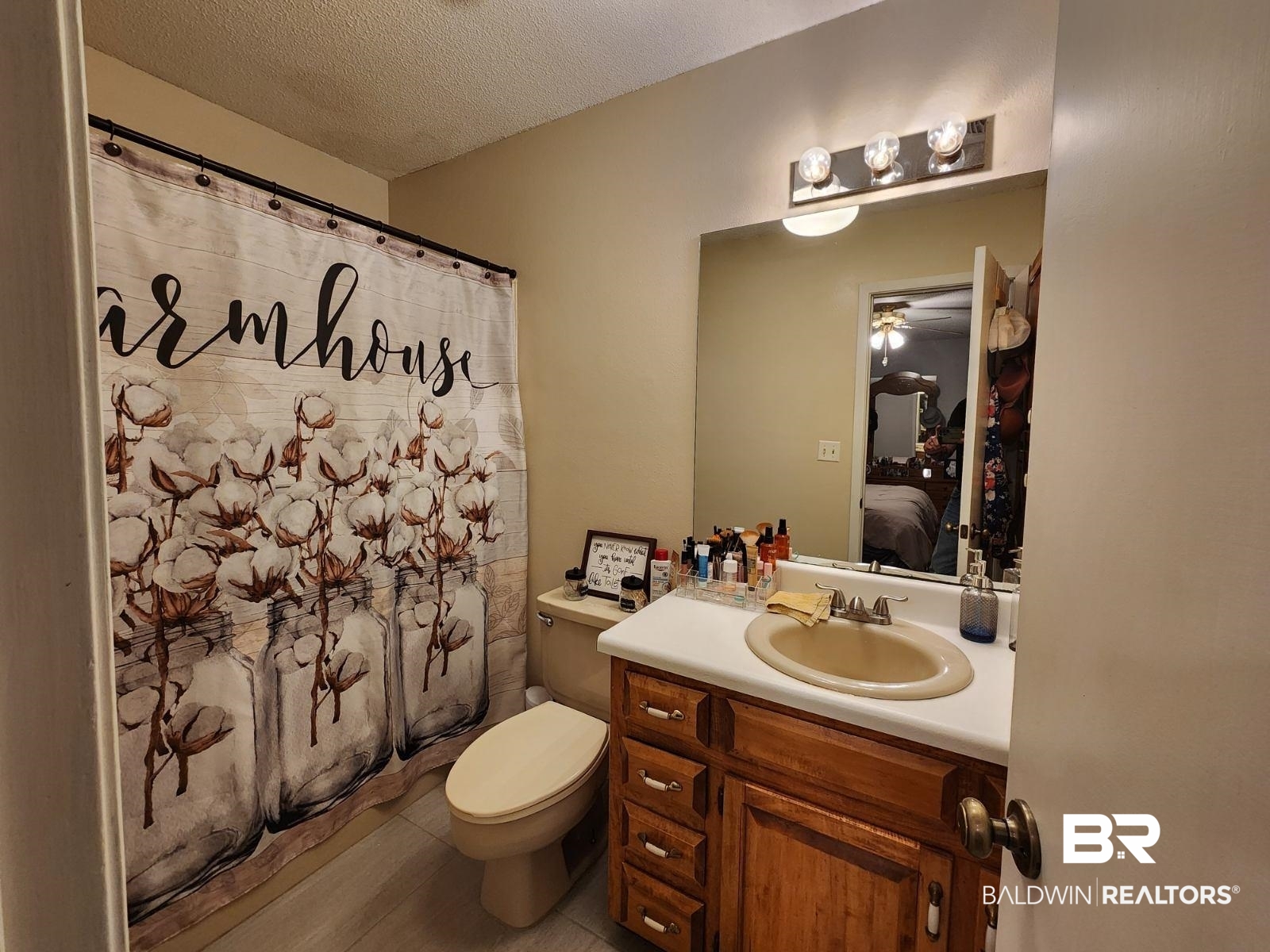 640 Horseshoe Road Brewton, AL 36426 - Photo 17 of 22 Bathroom with vanity, a textured ceiling, toilet, and tile patterned flooring