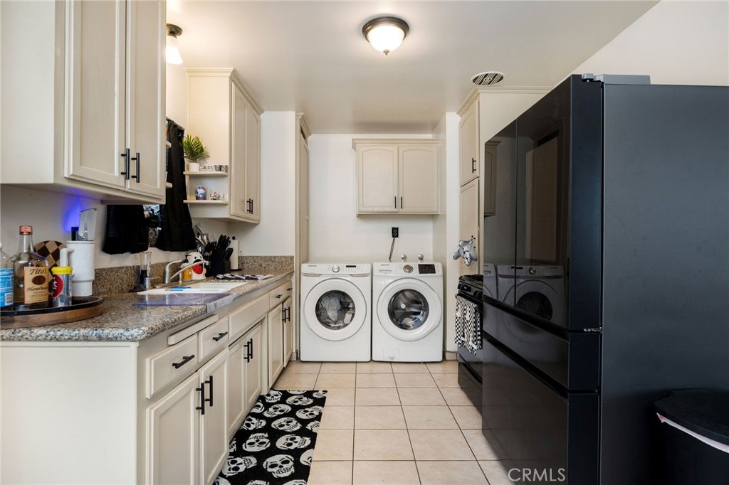 2615 Rockefeller Lane Redondo Beach, CA 90278 - Photo 19 of 33 a kitchen with a refrigerator a stove and white cabinets
