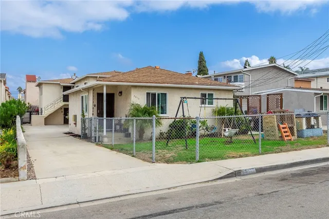 a front view of a house with a yard and potted plants