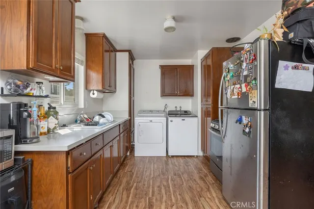 a kitchen with refrigerator and cabinets