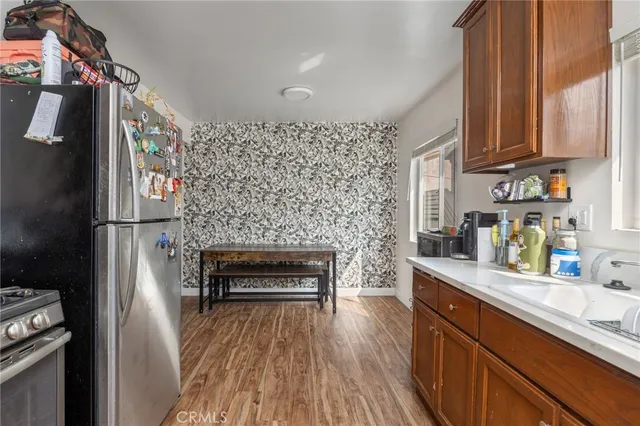 a kitchen with stainless steel appliances granite countertop a refrigerator and a stove top oven