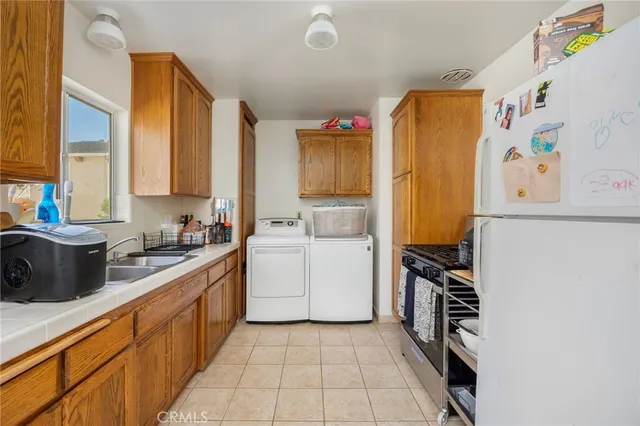 a kitchen with stainless steel appliances a stove a sink and a refrigerator