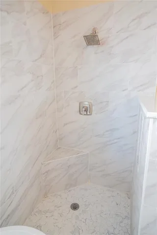 a view of a small space with wooden floor and a window