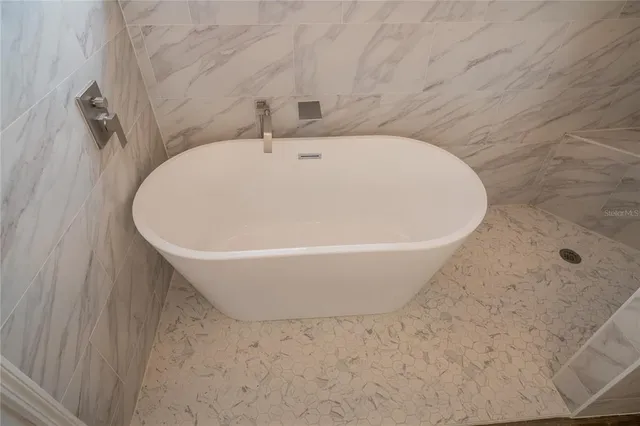 a view of empty room with window and wooden floor