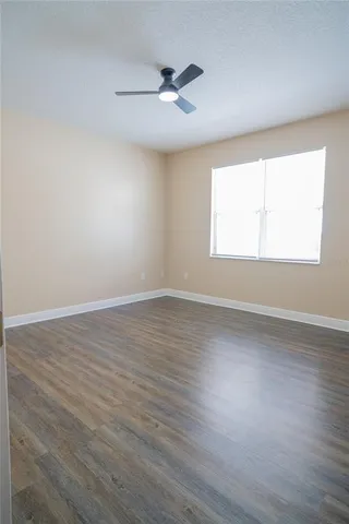 a view of a small space with wooden floor and a window