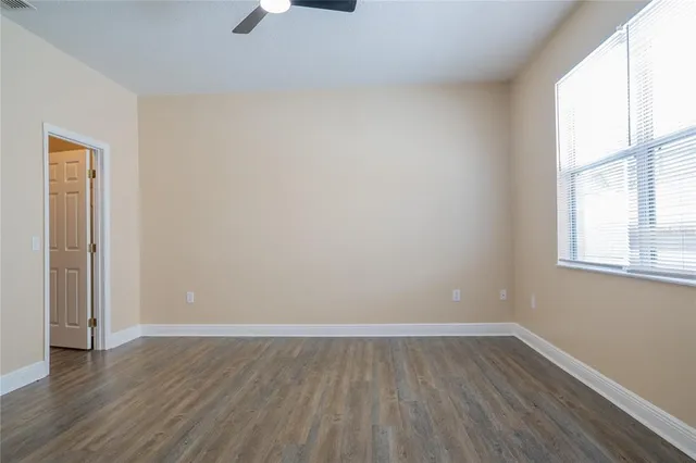 a view of an empty room with wooden floor