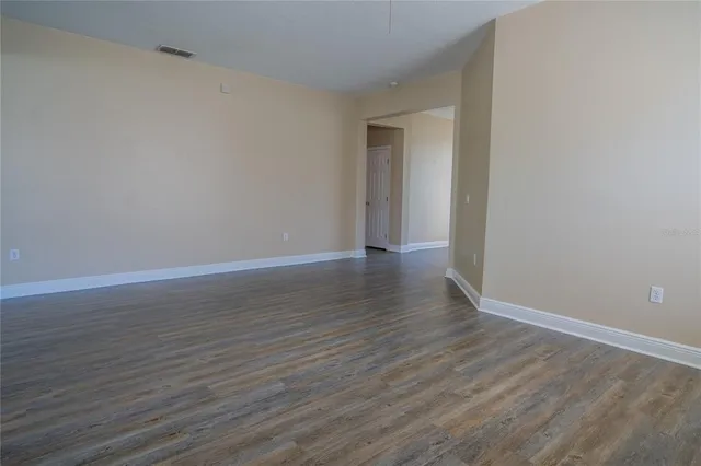 a view of a chair and table in backyard of the house