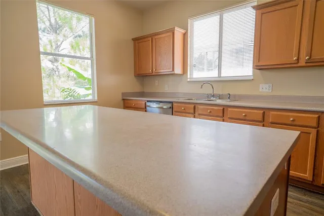 a view of a kitchen with granite countertop cabinets and a window