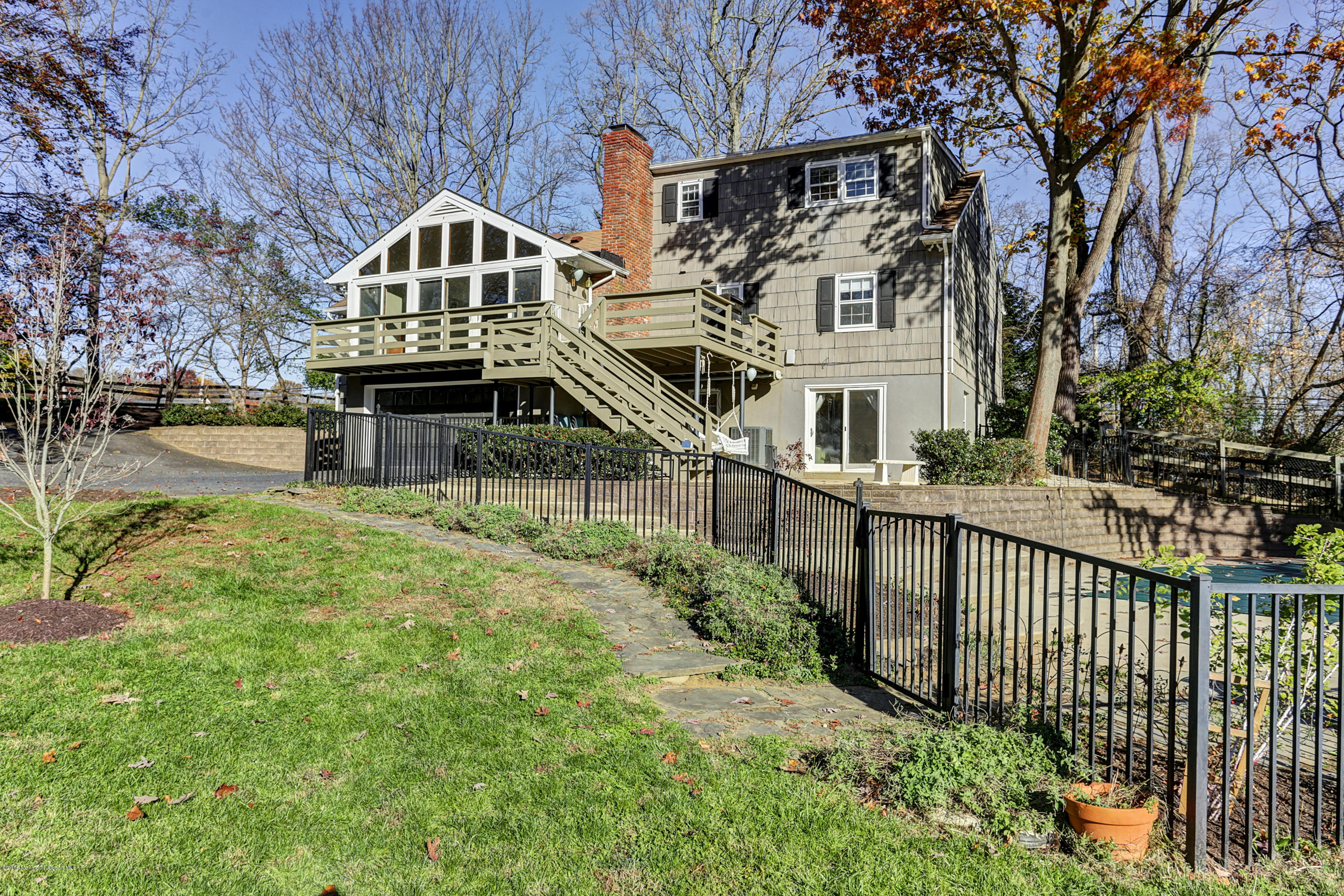 254 Newman Springs Road Colts Neck, NJ 07722 - Photo 2 of 30 a view of a house with wooden fence next to a river