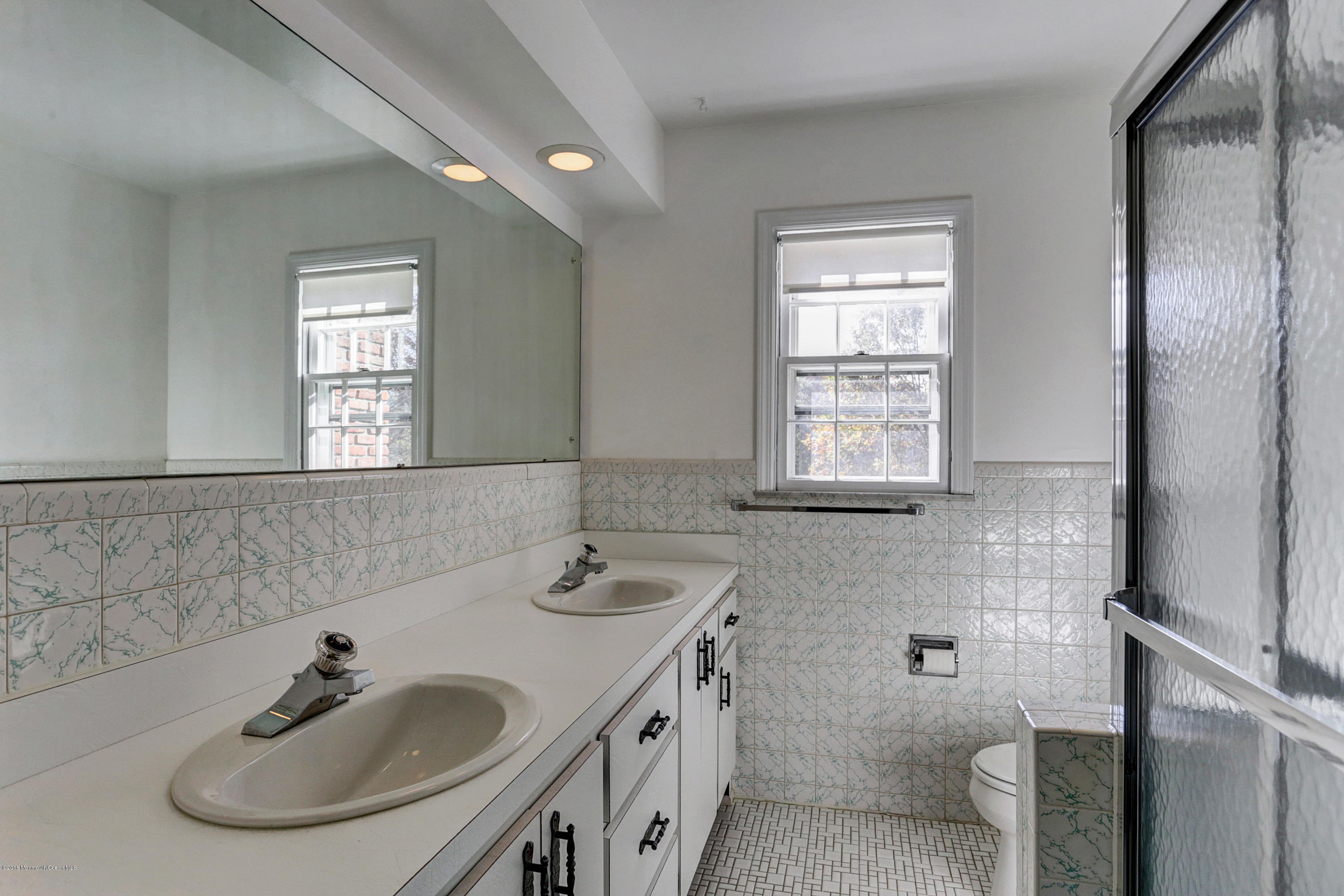 254 Newman Springs Road Colts Neck, NJ 07722 - Photo 22 of 30 a bathroom with 2 sink and a mirror