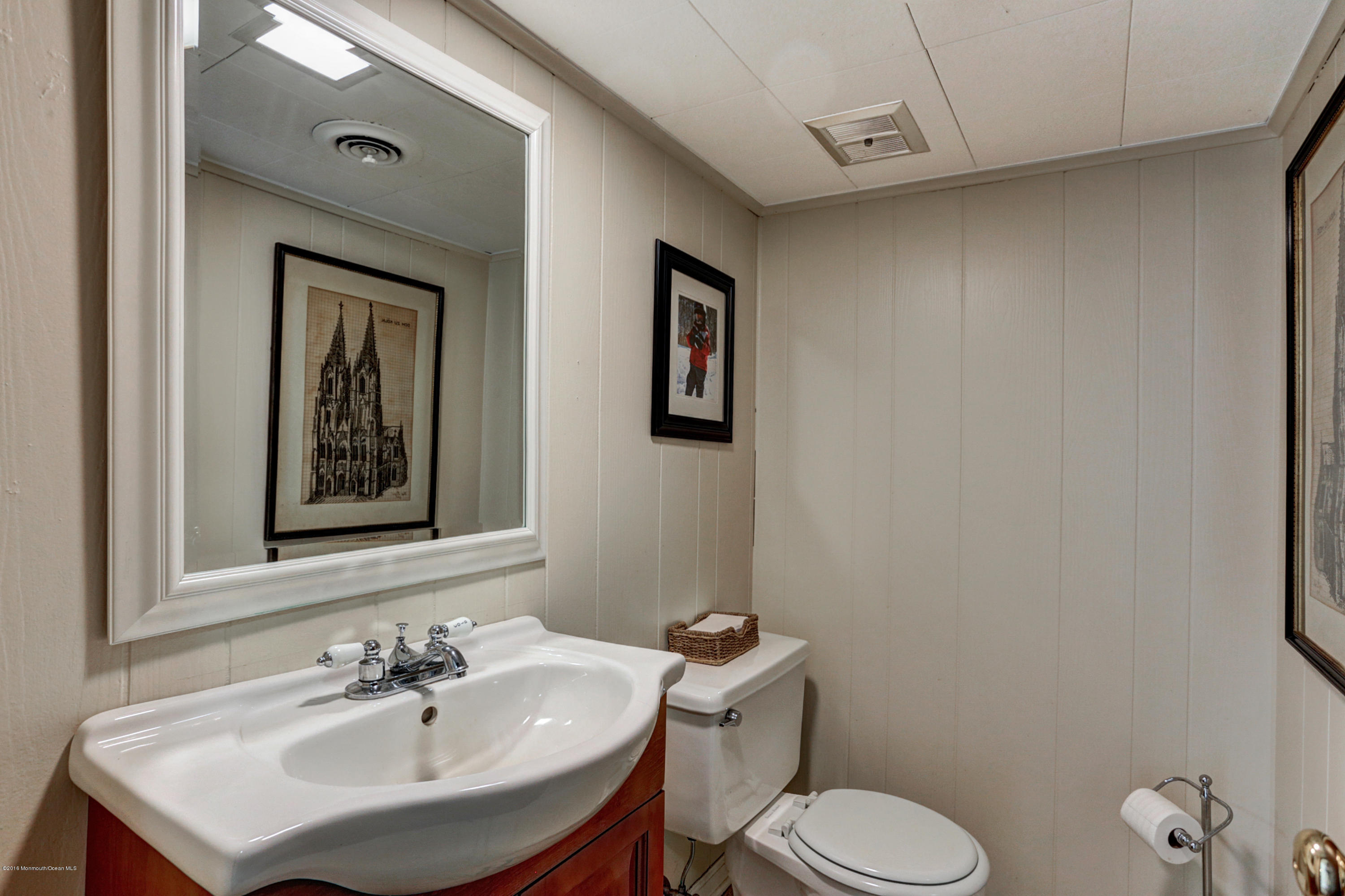 254 Newman Springs Road Colts Neck, NJ 07722 - Photo 25 of 30 a bathroom with a toilet sink and mirror