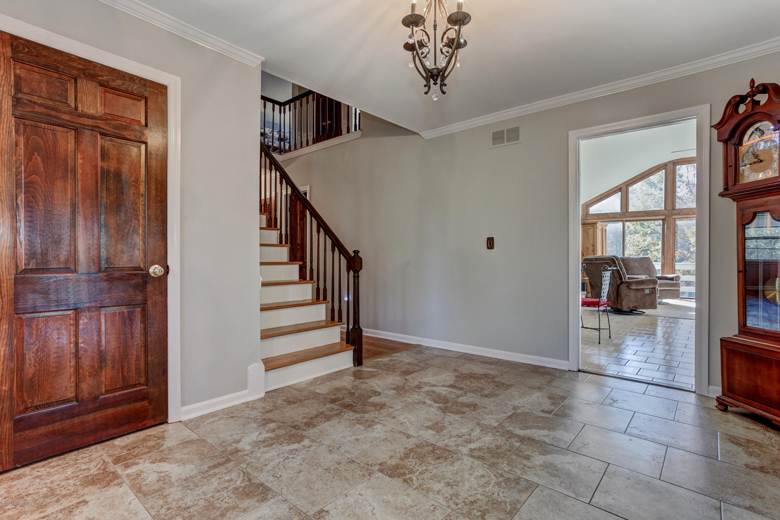 254 Newman Springs Road Colts Neck, NJ 07722 - Photo 5 of 30 a view of a livingroom with wooden floor and stairs